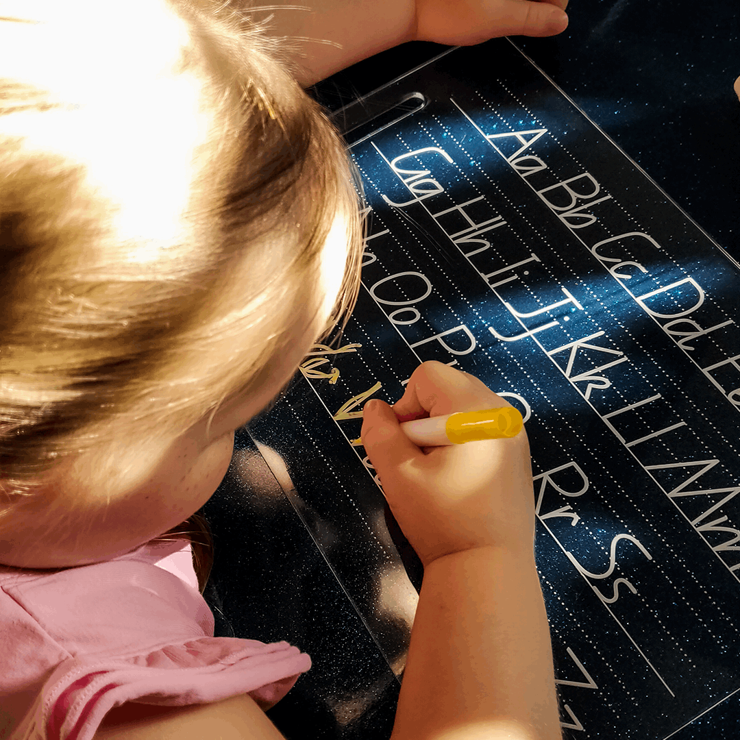Young Girl using Alphabet Tracing Board