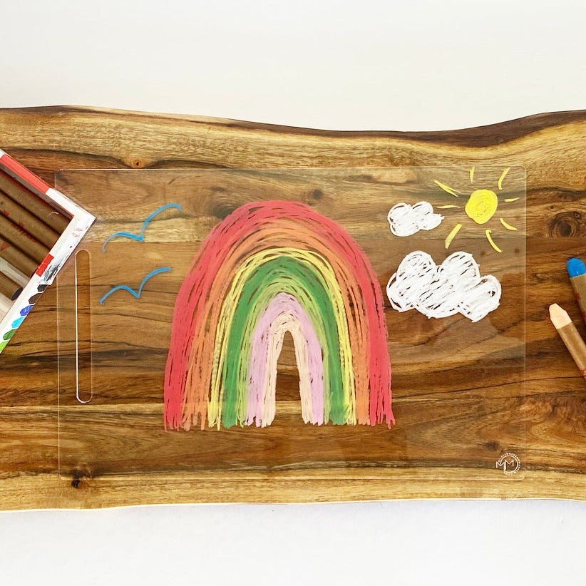 Acrylic drawing board with child's rainbow, clouds and sun drawing