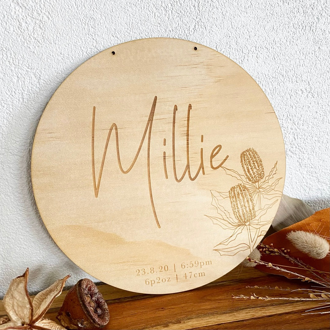 Baby birth announcement plaque featuring banksia