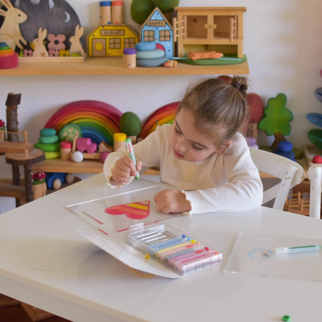 Little girl using acrylic drawing board