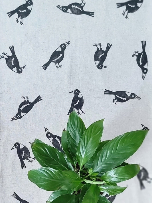 Top down view of magpie table runner with green plant